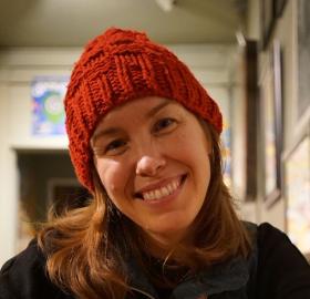 Female person with red hat on smiling